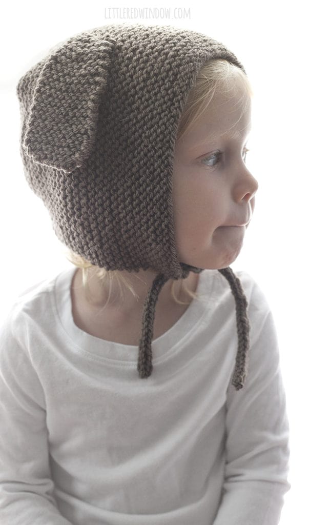 The puppy dog bonnet knitting pattern is knit in garter stitch and has two cute floppy puppy dog ears on the sides!