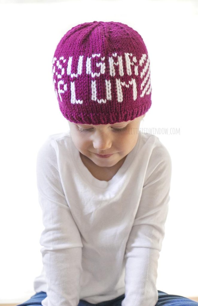 Cute toddler wearing a knit hat that says 