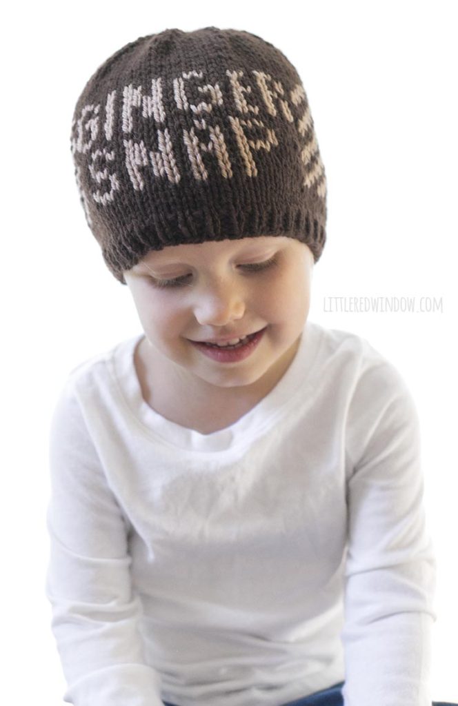 Adorable toddler wearing a knit hat that says 