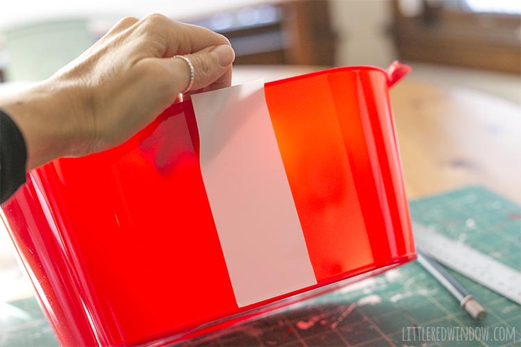 It's easy to apply vinyl to a craft project like this Santa Party Bucket by hand even without expensive transfer tape!