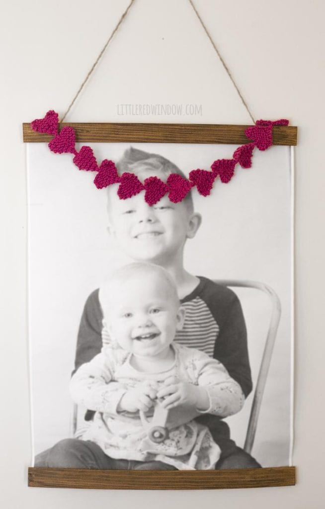 Easy knit heart garland strung over a family photo!