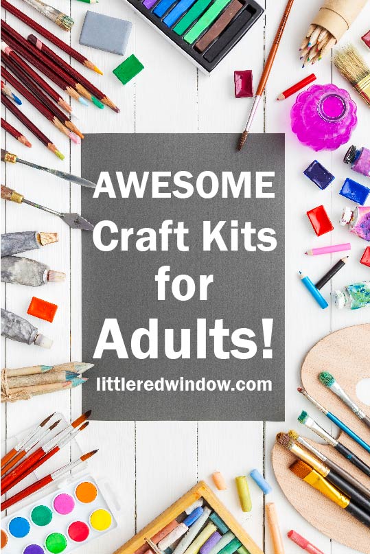 Tons of colorful craft supplies on a white table with the words AWESOME CRAFT KITS FOR ADULTS in the center