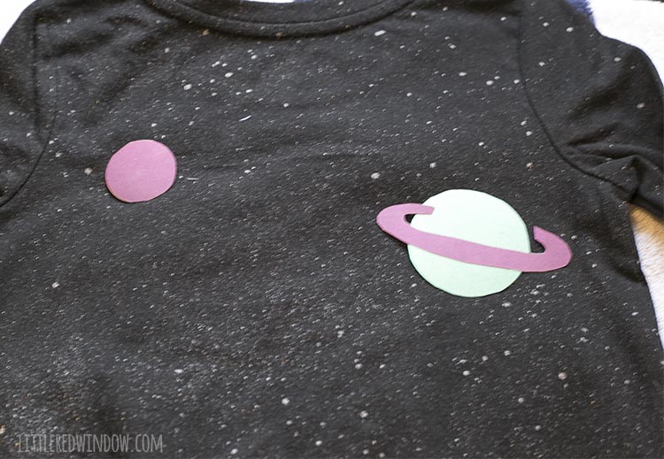 planet vinyl shapes positioned on black long sleeved tshirt as part of an outer space costume