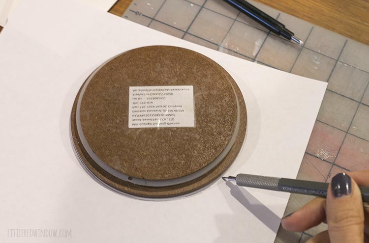 pencil tracing around a wood circle on top of white paper