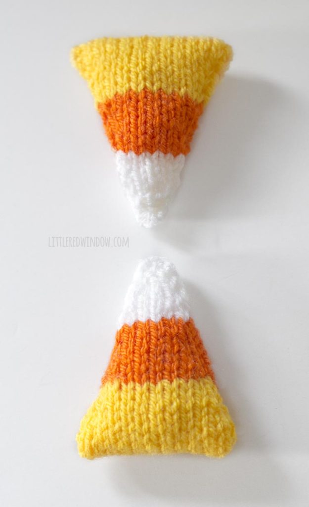 two knit candy corn shapes mirror image above the other on a white background
