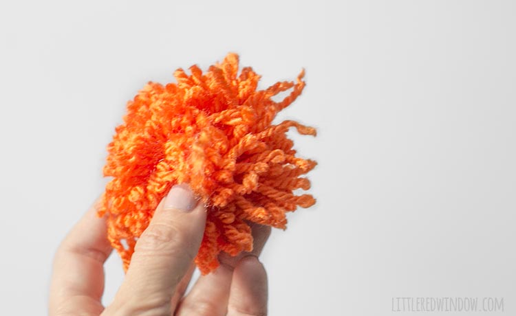 messy orange yarn pom pom
