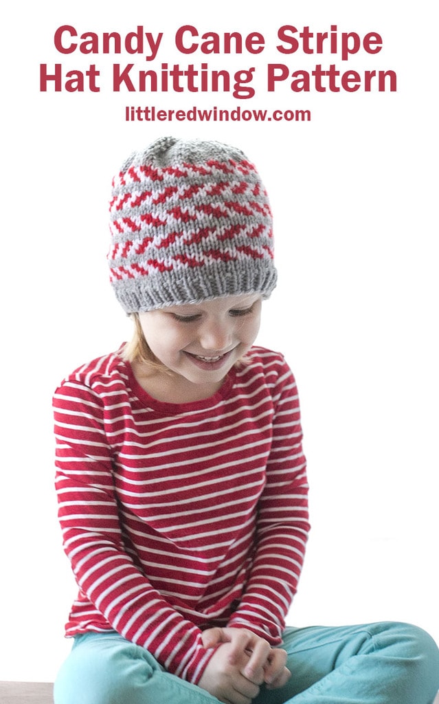 The candy cane stripe hat knitting pattern is an adorable Christmas baby hat with alternating candy cane stripes on a gray background, it's the perfect holiday knit!