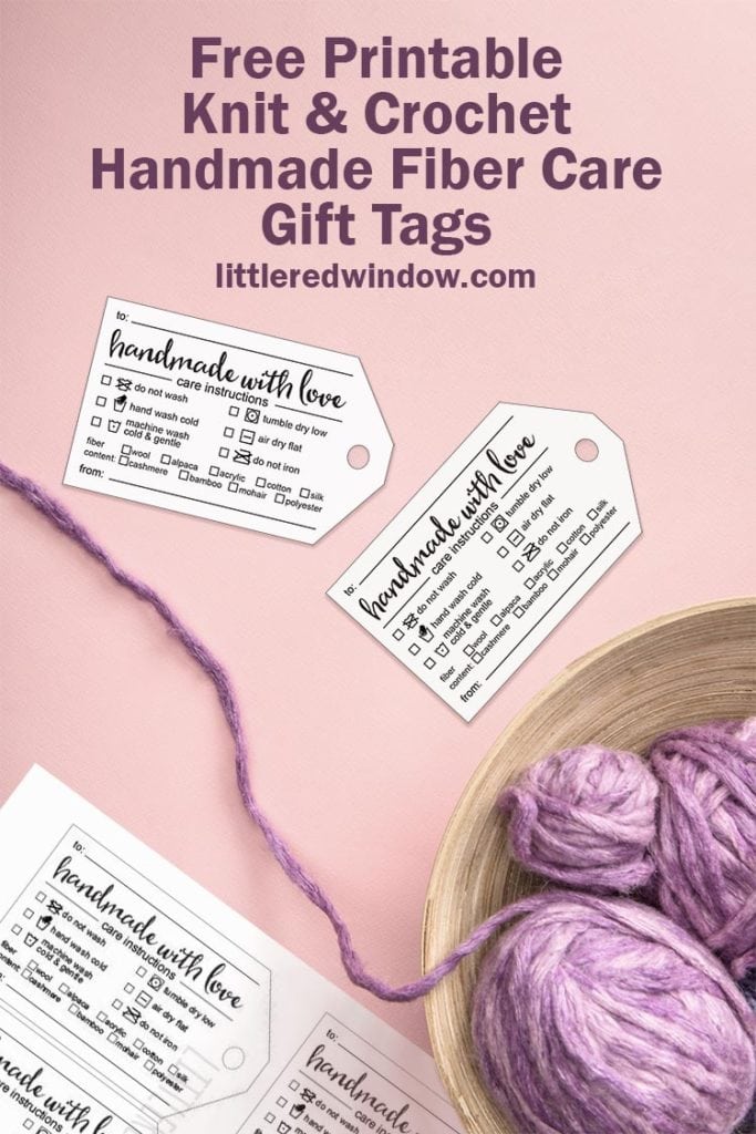 purple yarn in a bowl on a pink background with handmade fiber care instruction gift tags scattered around