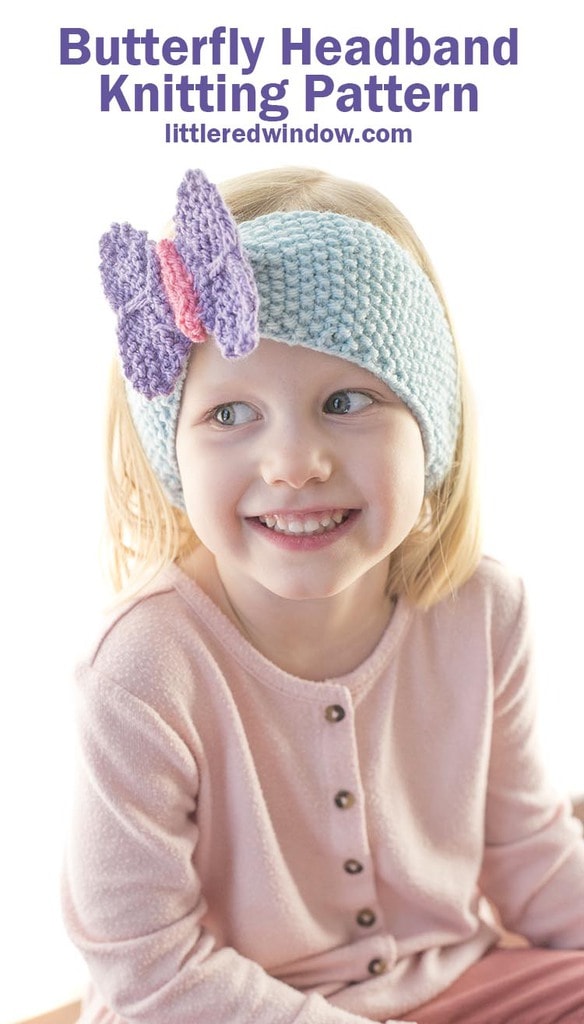 smiling girl in pink shirt wearing light blue seed stitch knit headband with a purple and pink knit butterfly perched on top