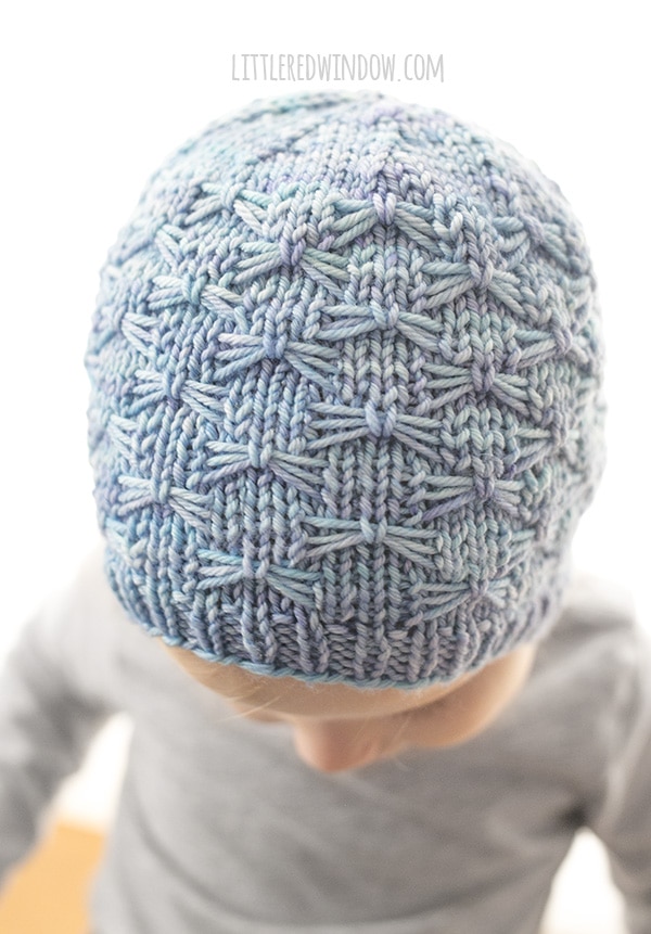closeup view of the stitches on the little girl wearing the butterfly stitch hat