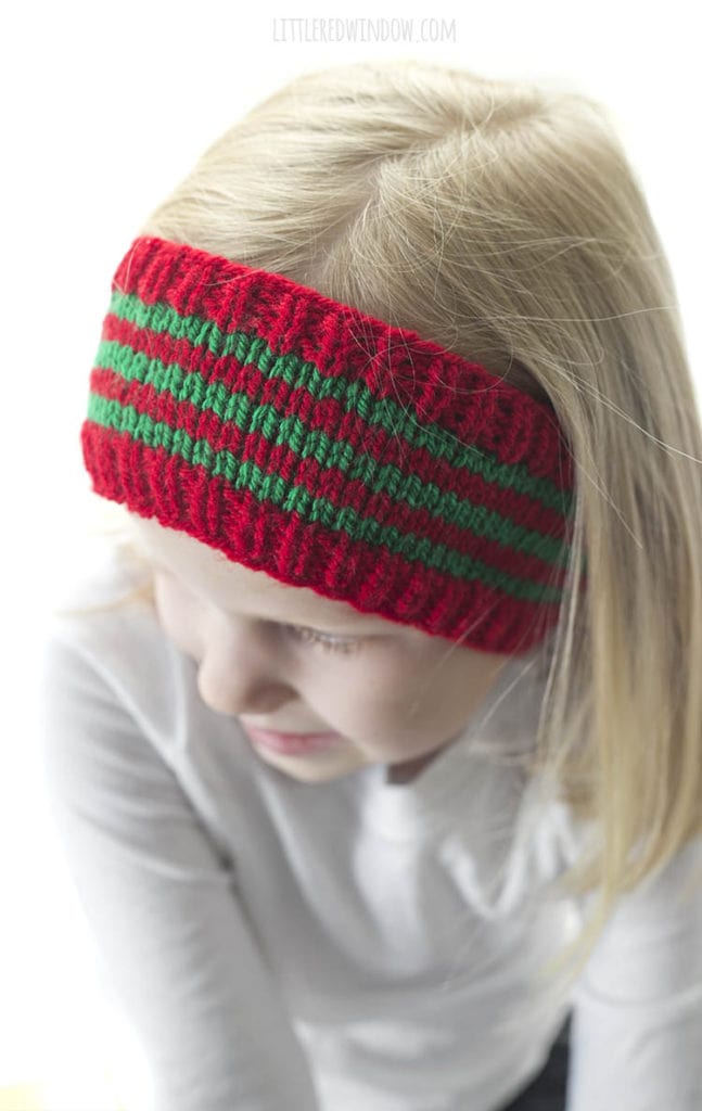closeup of red and green striped knit headband with red ribbed trim on a little girl