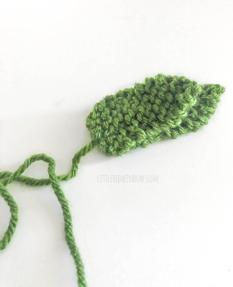 one short and one tall knit pineapple leaf sewed together on top of each other on a white backgroun