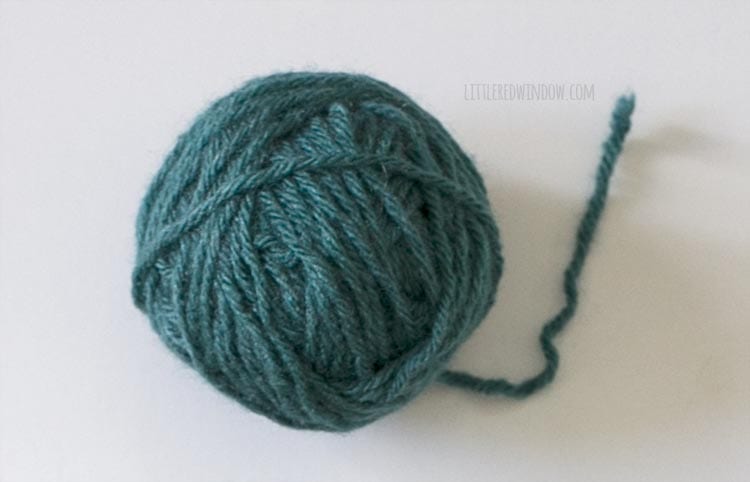 Teal ball of yarn on a white background