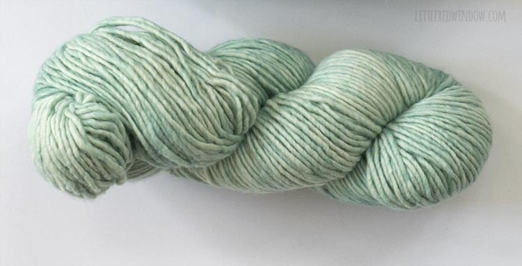 mint colored twisted hank of yarn on a white background