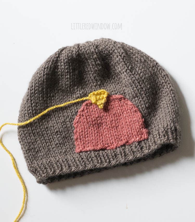 robin hat with little yellow triangle beak laid on top