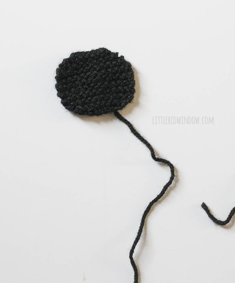 closeup of black knit circle that forms the sheeps face