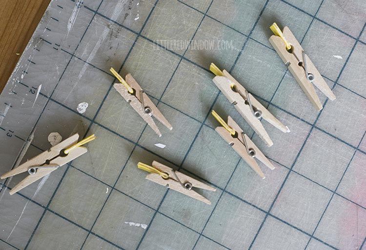 folded yellow faux leather strips held by clothespins while glue dries