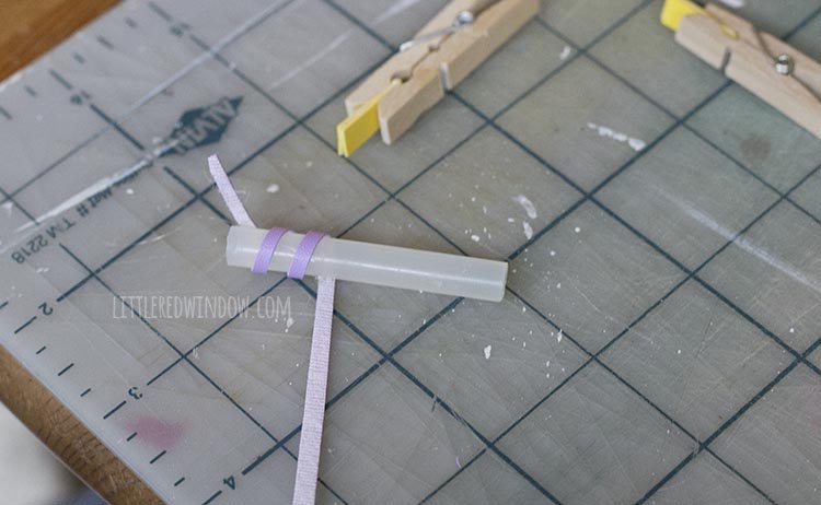 glue stick segment with purple strip wrapped partially around it diagonally