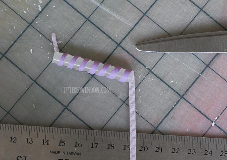 glue stick segment with purple strip wrapped all the way around it diagonally