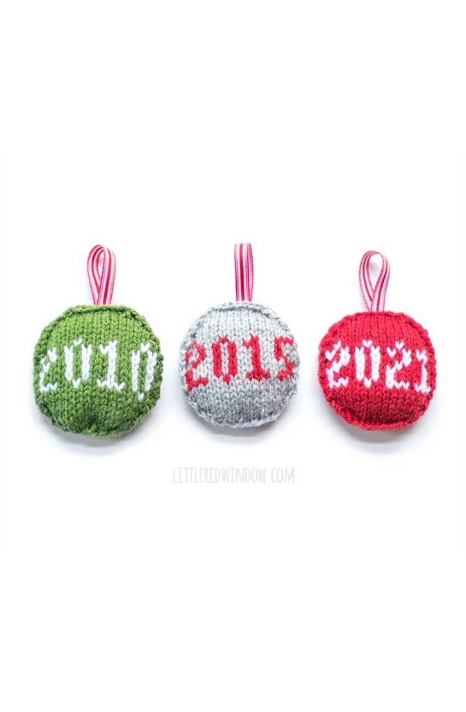 three round flat knit ornaments in green gray and red with the dates 2010 2015 and 2021 on them