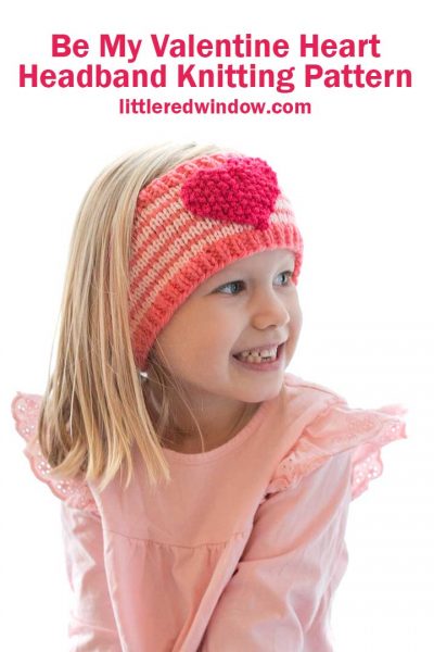 smiling girl wearing heart headband looking far away off to the right