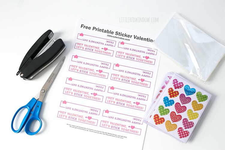 sheet of valentine labels stickers stapler and scissors on a white background
