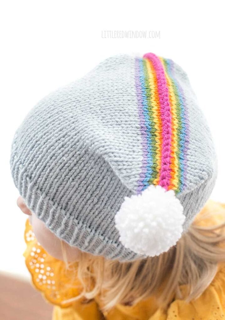 closeup top view of rainbow double pom hat knitting pattern