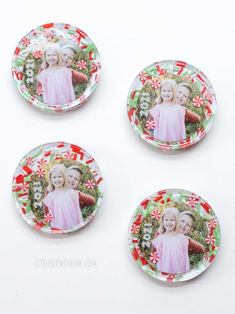 four finished photo resin christmas ornaments on a white background