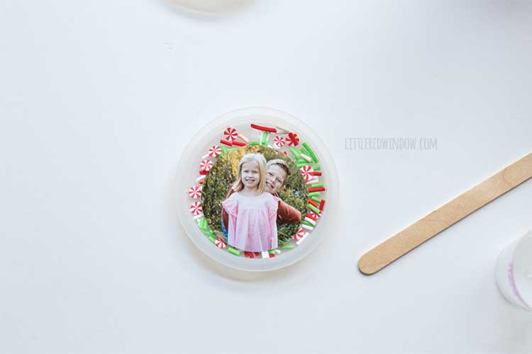 ornament mold with sprinkles with a circular photo of two kids on top