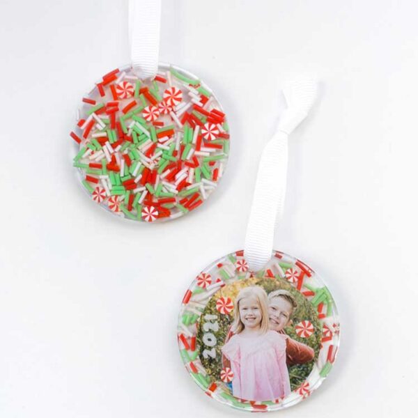 two finished resin christmas ornaments one showing the photo on the front and one showing the sprinkles on the back on a white background