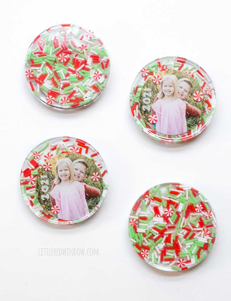 four finished resin christmas ornaments on a white background two showing the front of the ornament with photos and two showing the backs of the ornaments with sprinkles