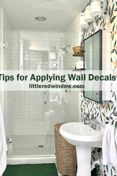 white bathroom with green and orange tangerine print wall decals that ldook like wallpaper