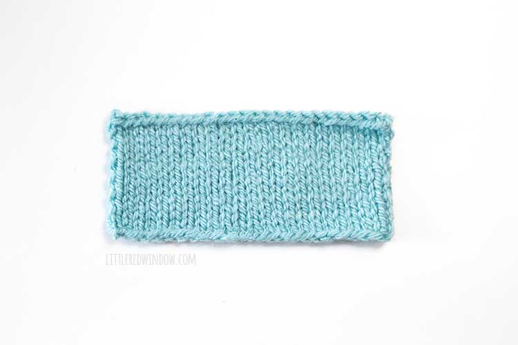 light blue rectangle knitting swatch on a white background showing backward loop cast on method