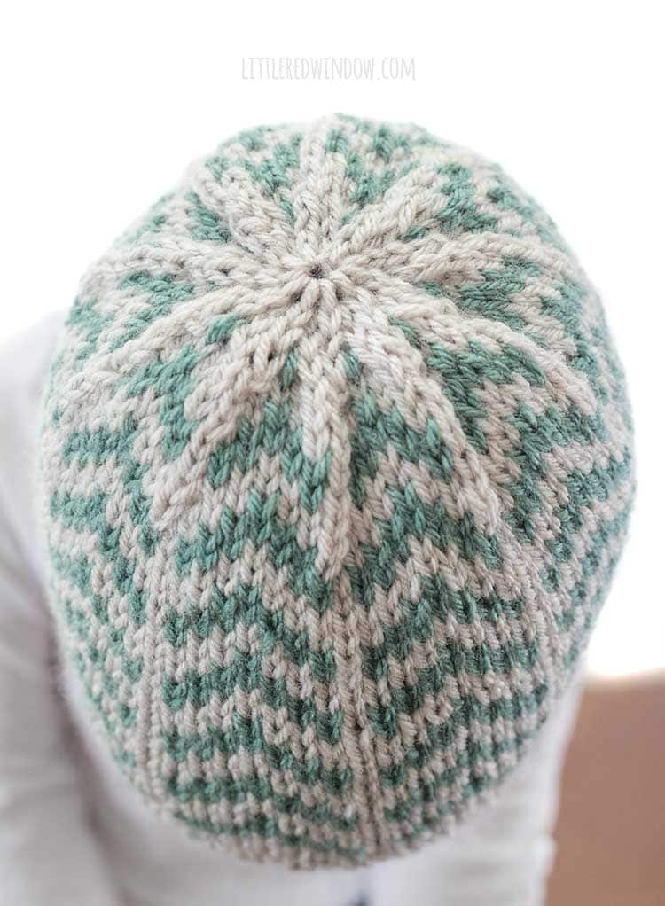 top view of tan and teal converging arrows hat