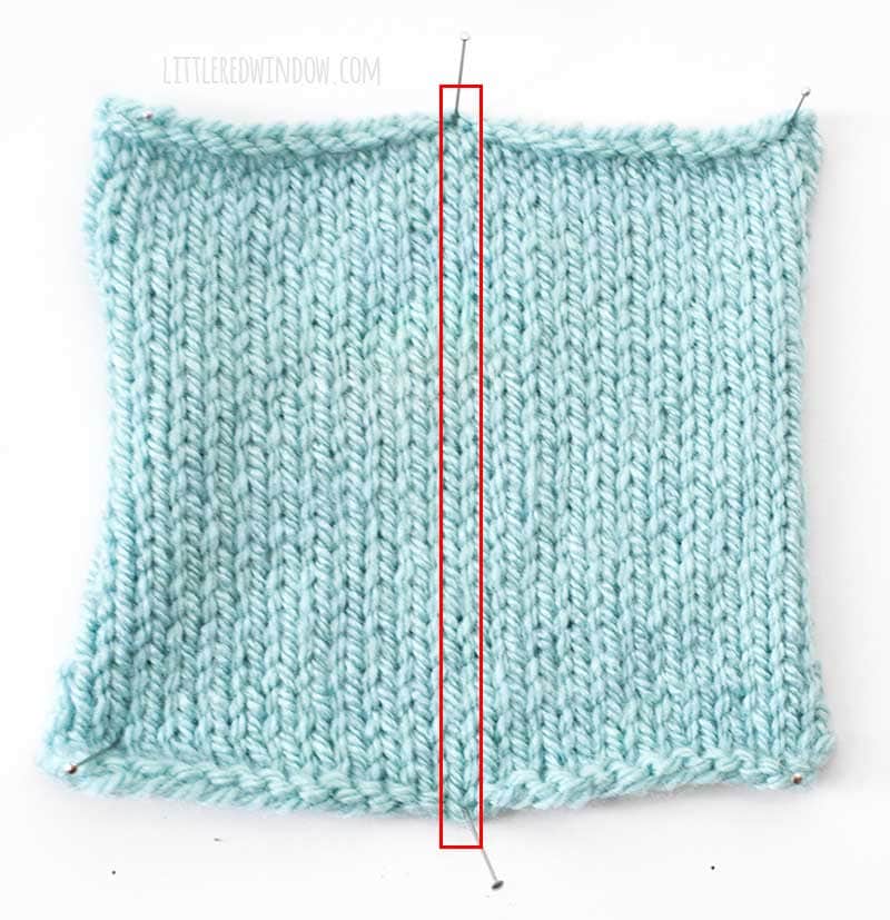 light blue swatch of stockinette stitch knitting with one column of stitches outlined in red