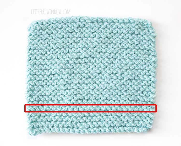 light blue square of garter stitch with a red rectangle around one single row.