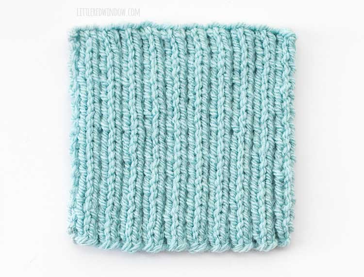 light blue 2x2 rib stitch knit swatch showing the right side of the knitting on a white background