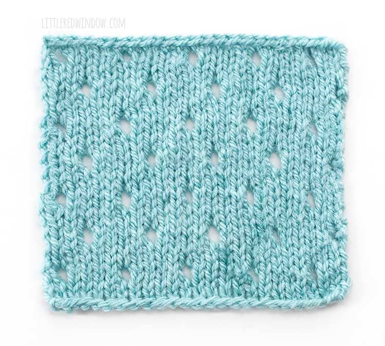 the right side of a light blue square swatch of basic eyelet stitch knitting on a white background