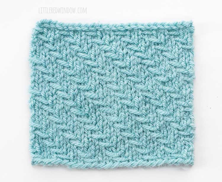 The right side of a square of light blue swatch of diagonal woven slip stitch knitting on a white background