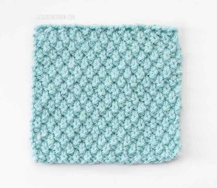 light blue square swatch of American moss stitch knitting with the wrong side up on a white background