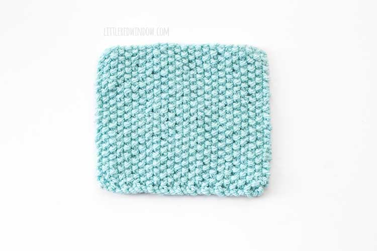 a light blue square swatch of the right side of seed stitch knitting on a white background