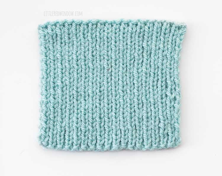light blue 1x1 rib stitch knit swatch showing the right side of the knitting on a white background