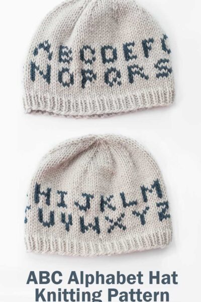 two tan knit hats on a white background with two rows of alphabet letters on them