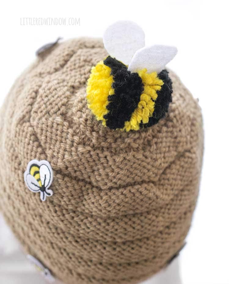 top view of the beehive hat with the black and yellow striped bee pom pom on top