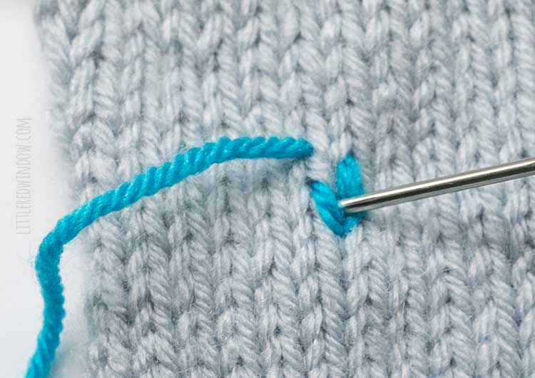 showing where to insert the yarn needle to complete the second duplicate stitch