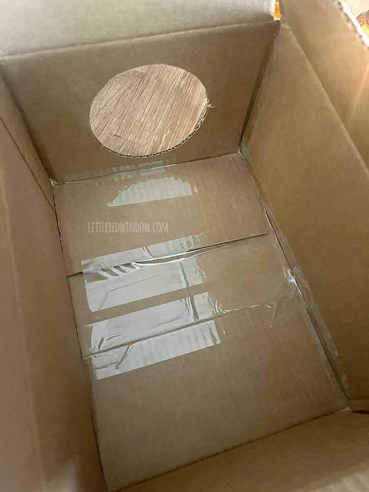 the inside of a cardboard box with the seams reinforced with clear packing tape