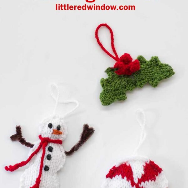 Three knit Christmas tree ornaments in the shape of a snowman a round red and white peppermint candy and a pair of holly leaves with red berries on a white background