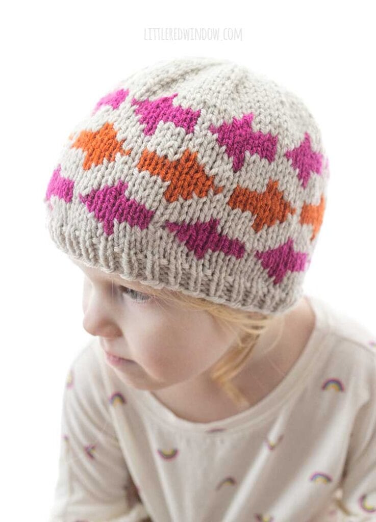 closeup of hot pink and bright orange arrow shapes on the which way arrow hat