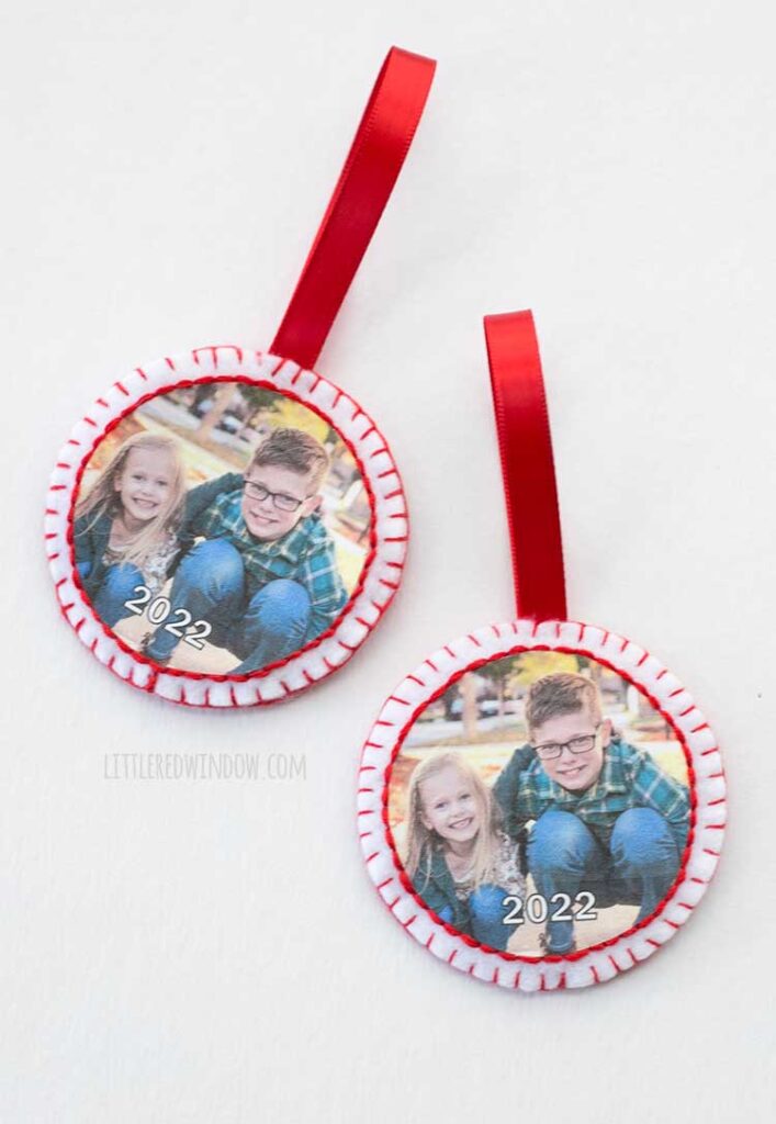 two round felt ornaments with embroidered edges around a photo of children