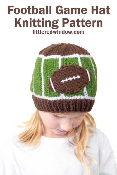 A child wearing a football hat—a knitted hat designed to resemble a football field with a football on top. Text above reads: "Football Game Hat Knitting Pattern littleredwindow.com".